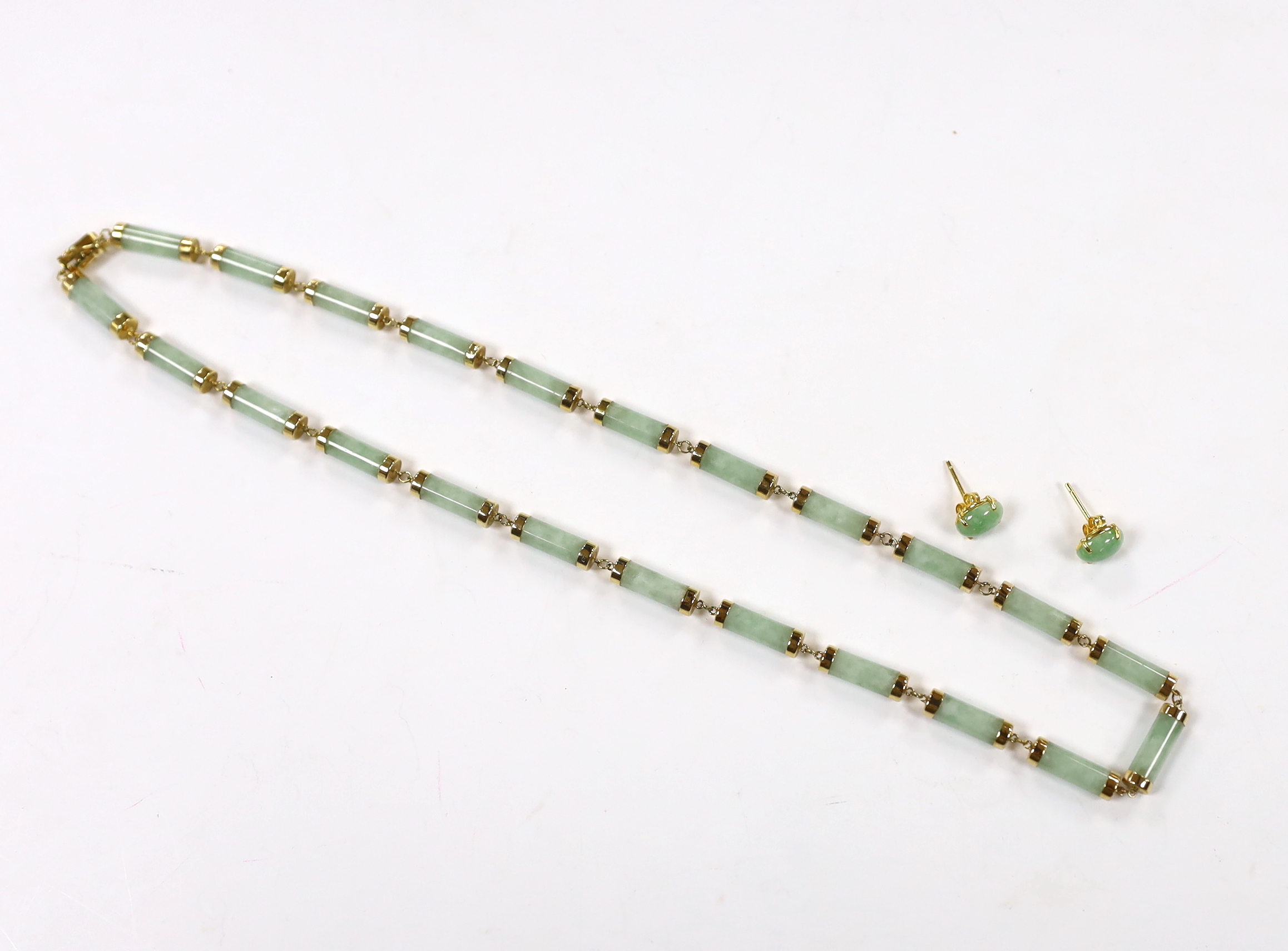A Chinese 14k yellow metal and jade set baton link necklace, 45cm, gross weight 26.3 grams, together with a pair of 750 yellow metal and cabochon jade set ear studs, gross weight 2.2 grams.